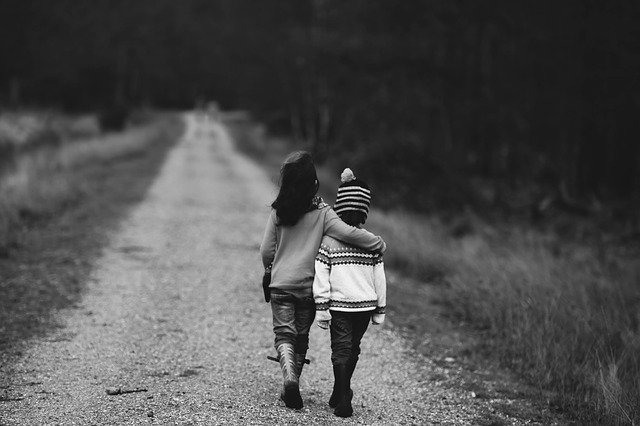 two friends walking down the road together